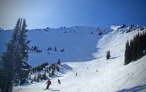 Skiers cruise down the intermediate run Lucky Shot at Crystal Mountain. Credit: John Nelson
