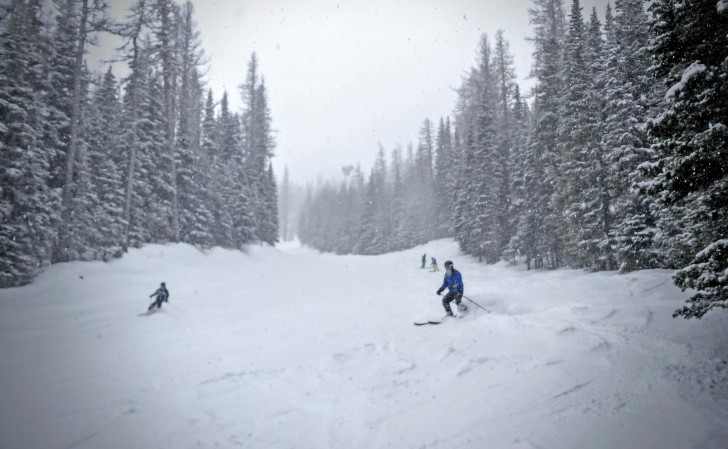 Skiers enjoy the soft snow on Chair 3 at Mission Ridge on a snowy day. Credit: John Nelson