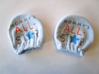 Mittens for newborn children, which can be bought at any store that carries infant clothing.