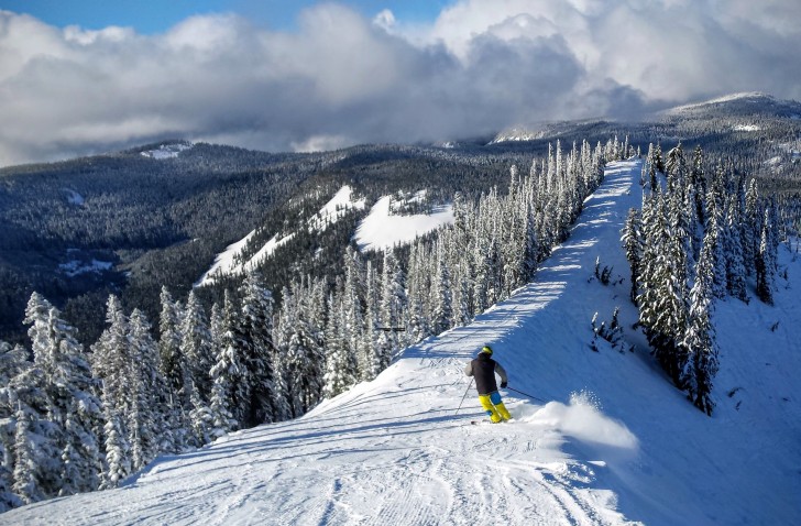 A skier heads off the top of Great White Express at White Pass. Credit: John Nelson