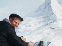 Ski Pioneer Film-Maker Warren Miller lacing up at the Matterhorn.  His beautiful and fun-filled films brought new people to skiing in the 60s and 70s. The WME company continues to produce over the top visual feasts.